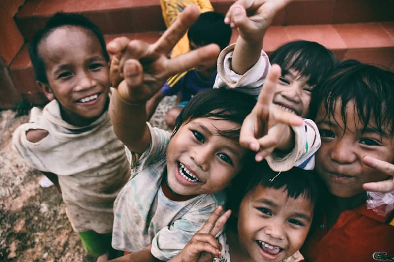 Children smiling at an outreach event