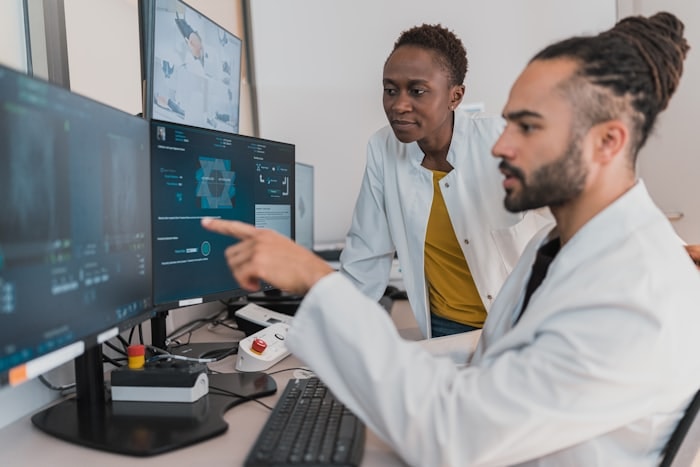 Clinicians discussing scans at a workstation