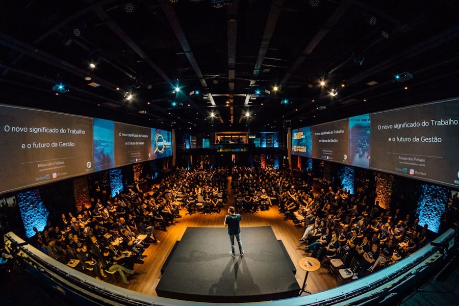 Speaker addressing a full auditorium