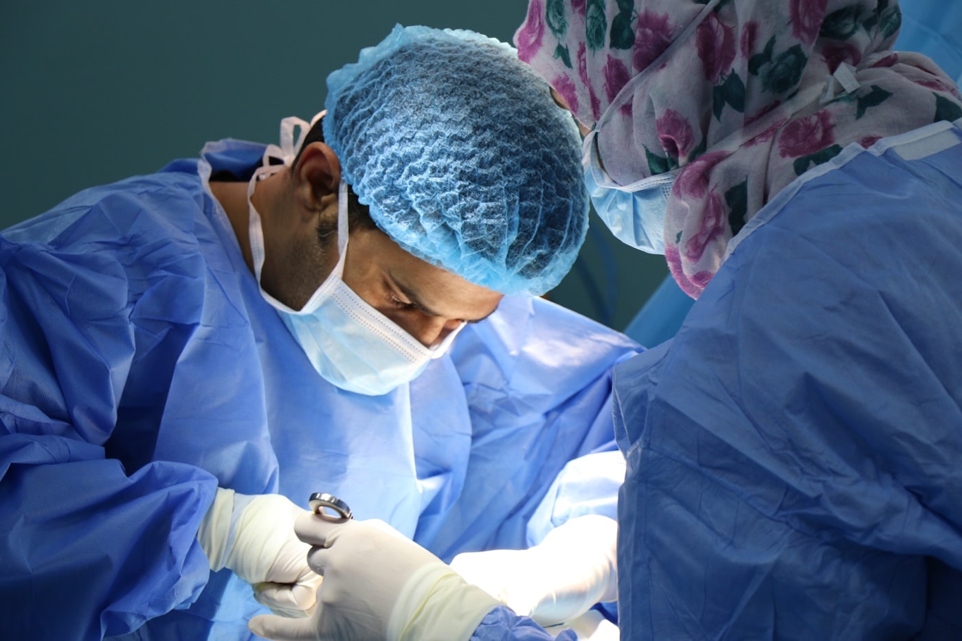 Two scrubbed surgeons working side by side at the operating table