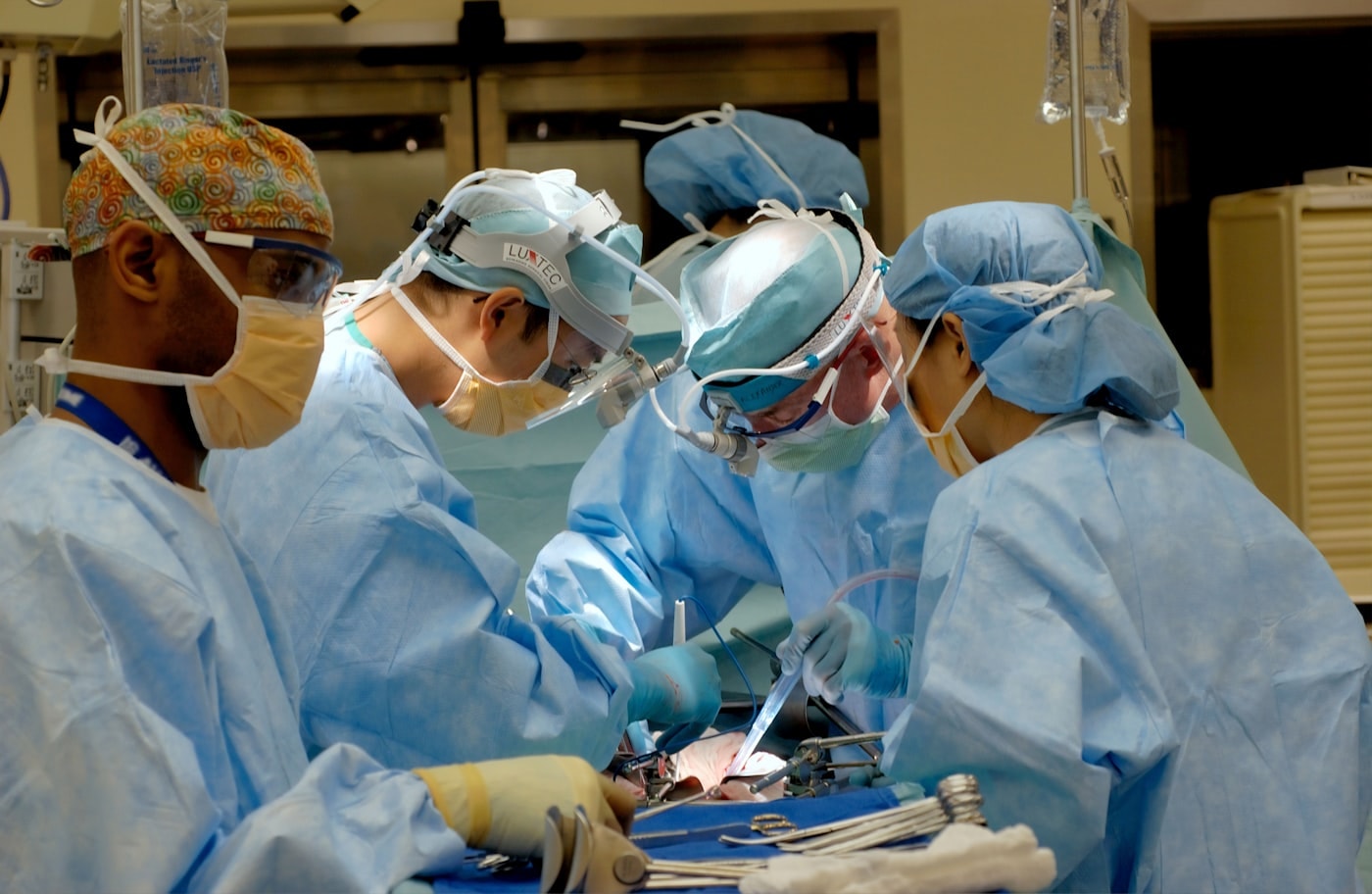A surgical team operating under theatre lights