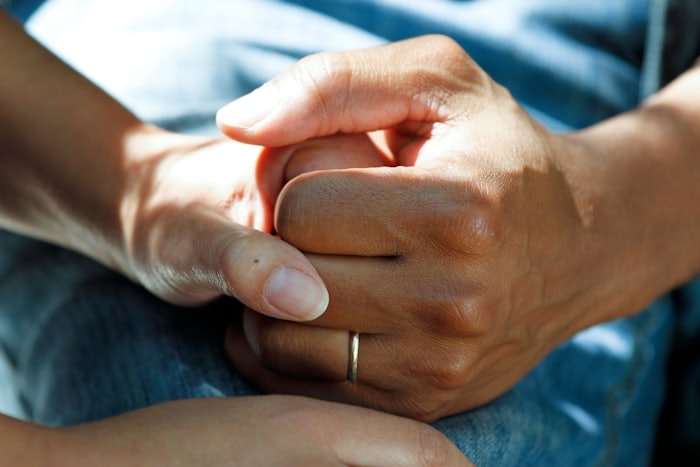 A clinician holding a patient's hands